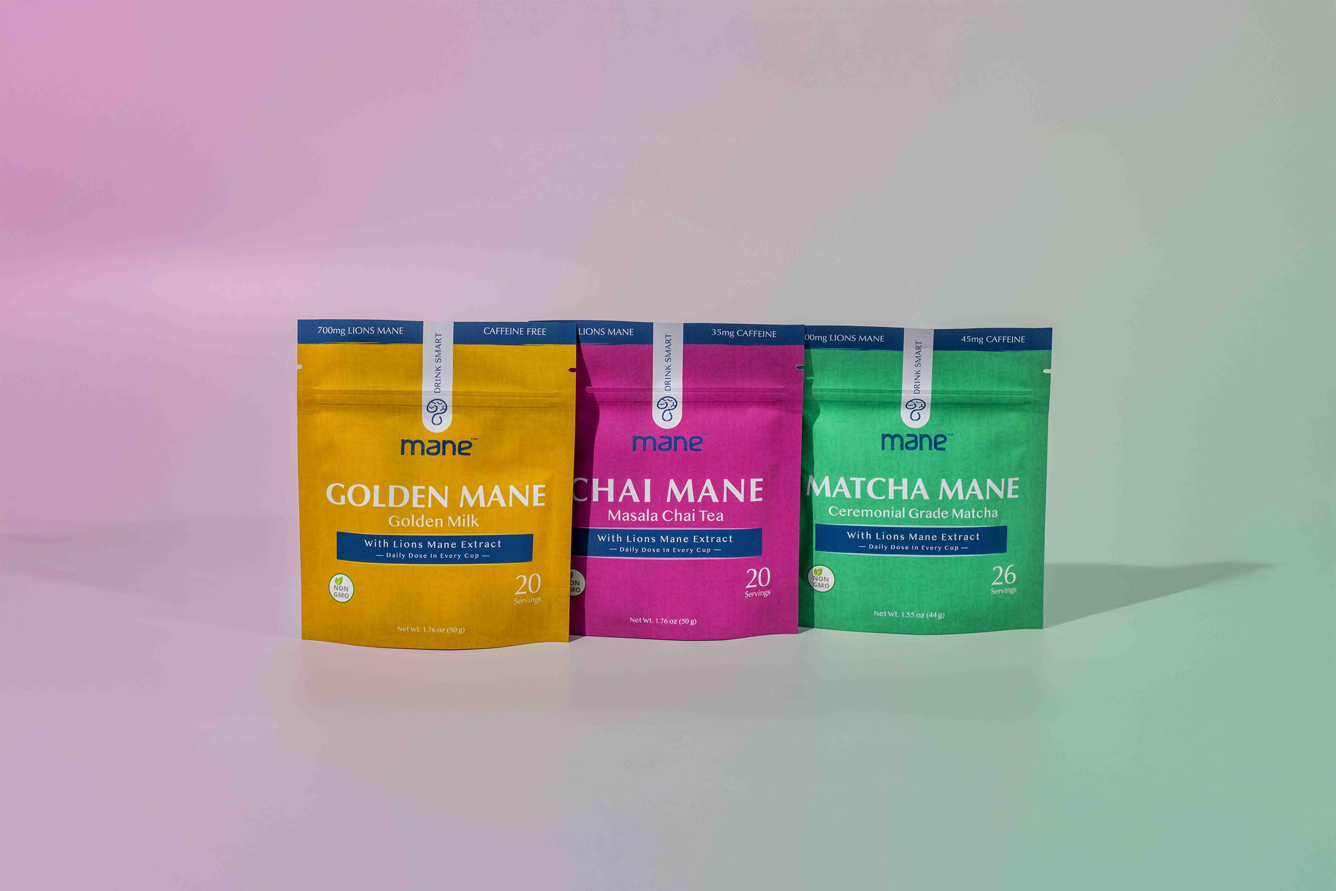 Three packages of Mane mushroom beverages in yellow, pink, and green on a gradient background.